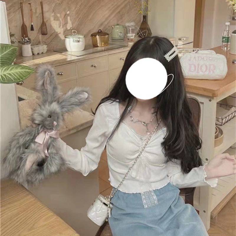 A Woman Wearing A Sweater With A Base Top