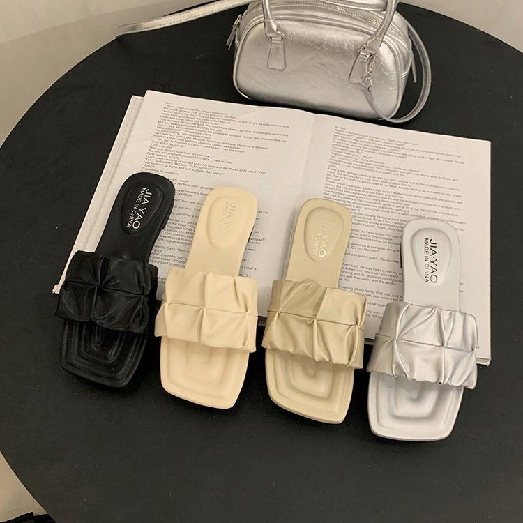 Minimalist pleated flat slide sandals in beige, black, champagne and silver colorways with square toe and ruched crisscross strap