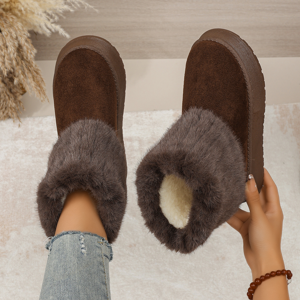 Brown platform ankle boots showing fluffy cuffs, plush interior and suede-look uppers