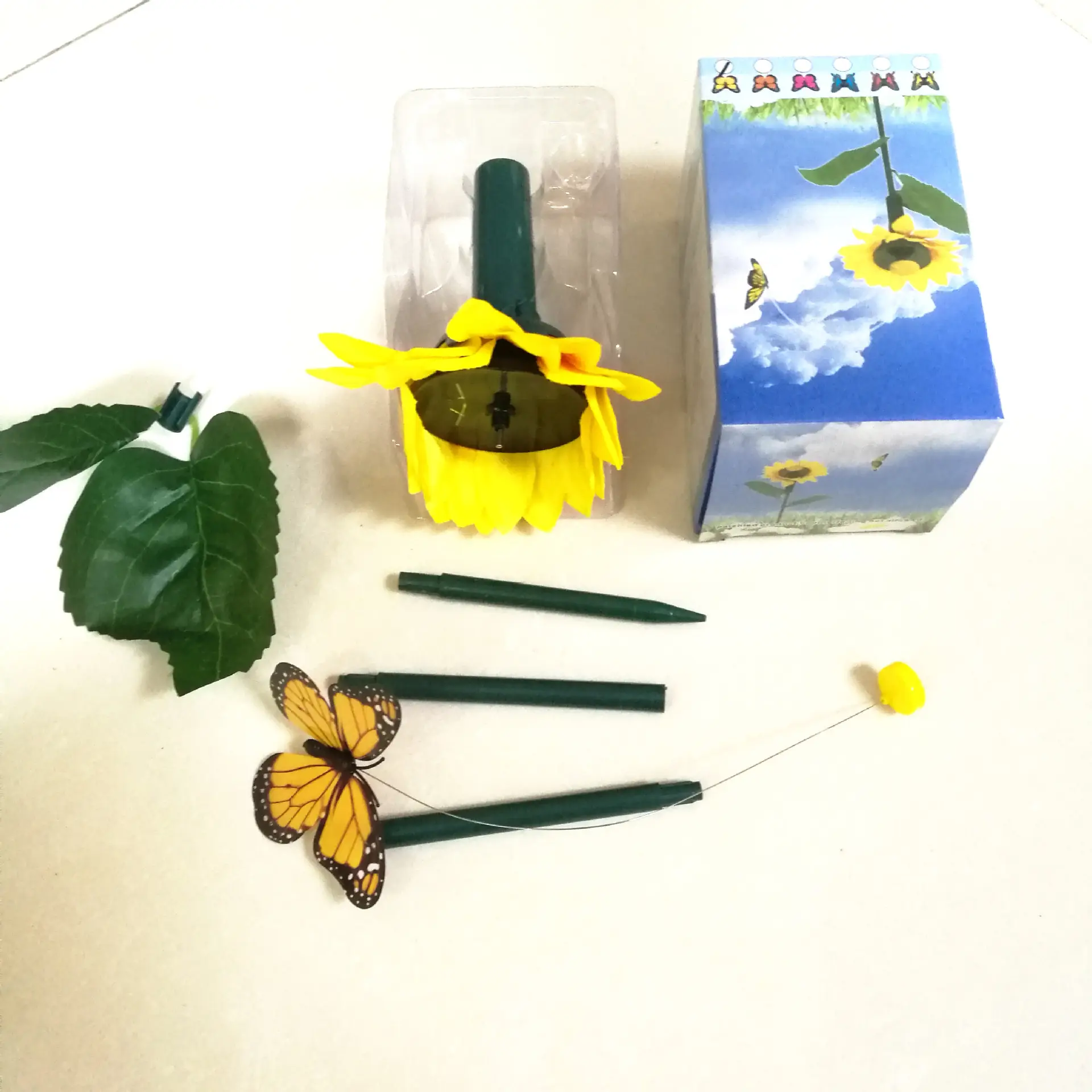 Solar Powered Butterfly with Sunflower Flying Vivid