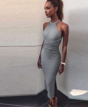 A long, sleeveless, slim dress with a backless tie