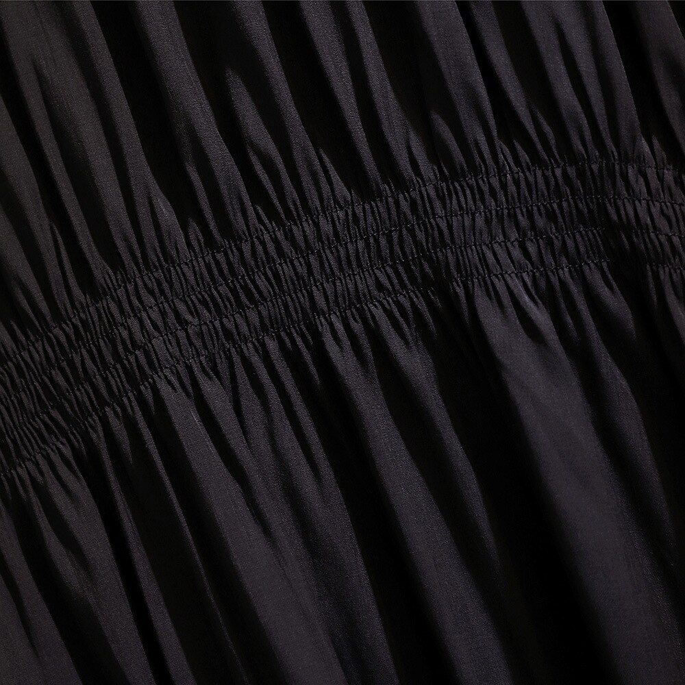 Loose casual pleated skirt covering belly