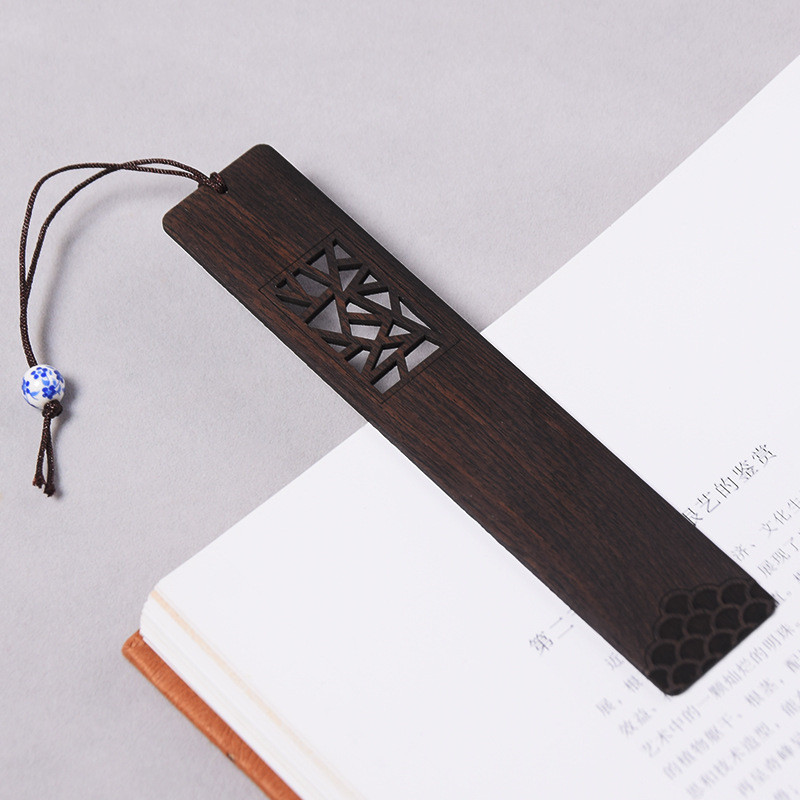 Hollowed wooden bookmark decorated with traditional Chinese lattice patterns.