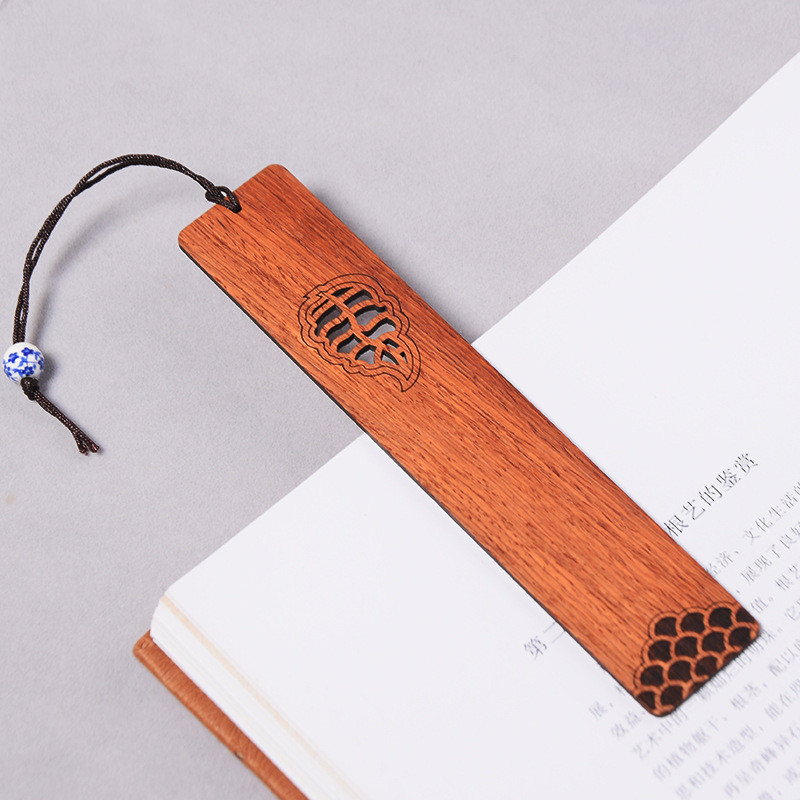 Close-up detail of laser-cut window lattice pattern on wooden bookmark
