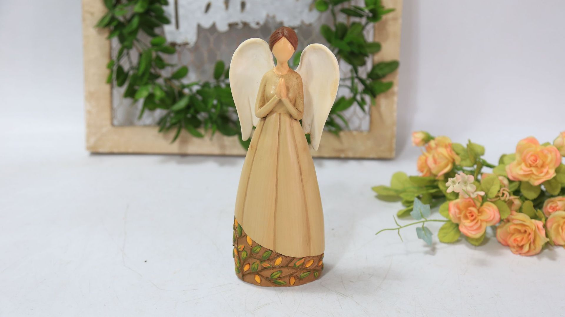 Brown angel with folded hands