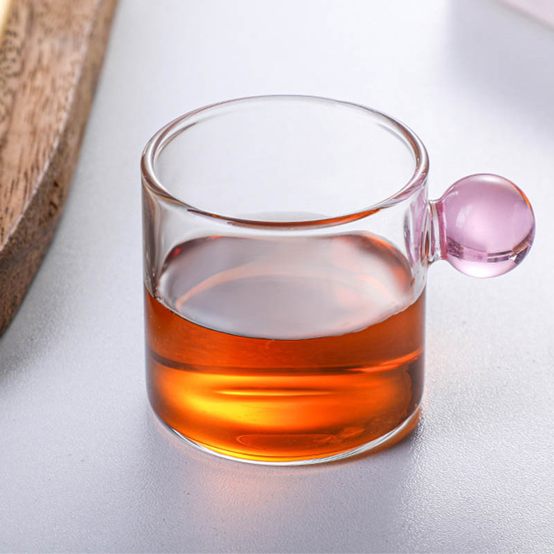 Coffee cup with glass sphere handle in Nordic style.