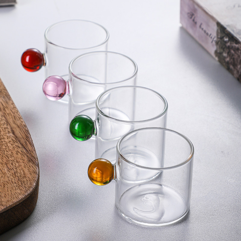 Coffee cup with glass sphere handle in Nordic style.