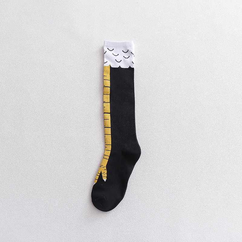 Fun and creative novelty knee-high sock designed to resemble a bird’s leg, featuring a black base with a yellow claw and white feather-like top detail.