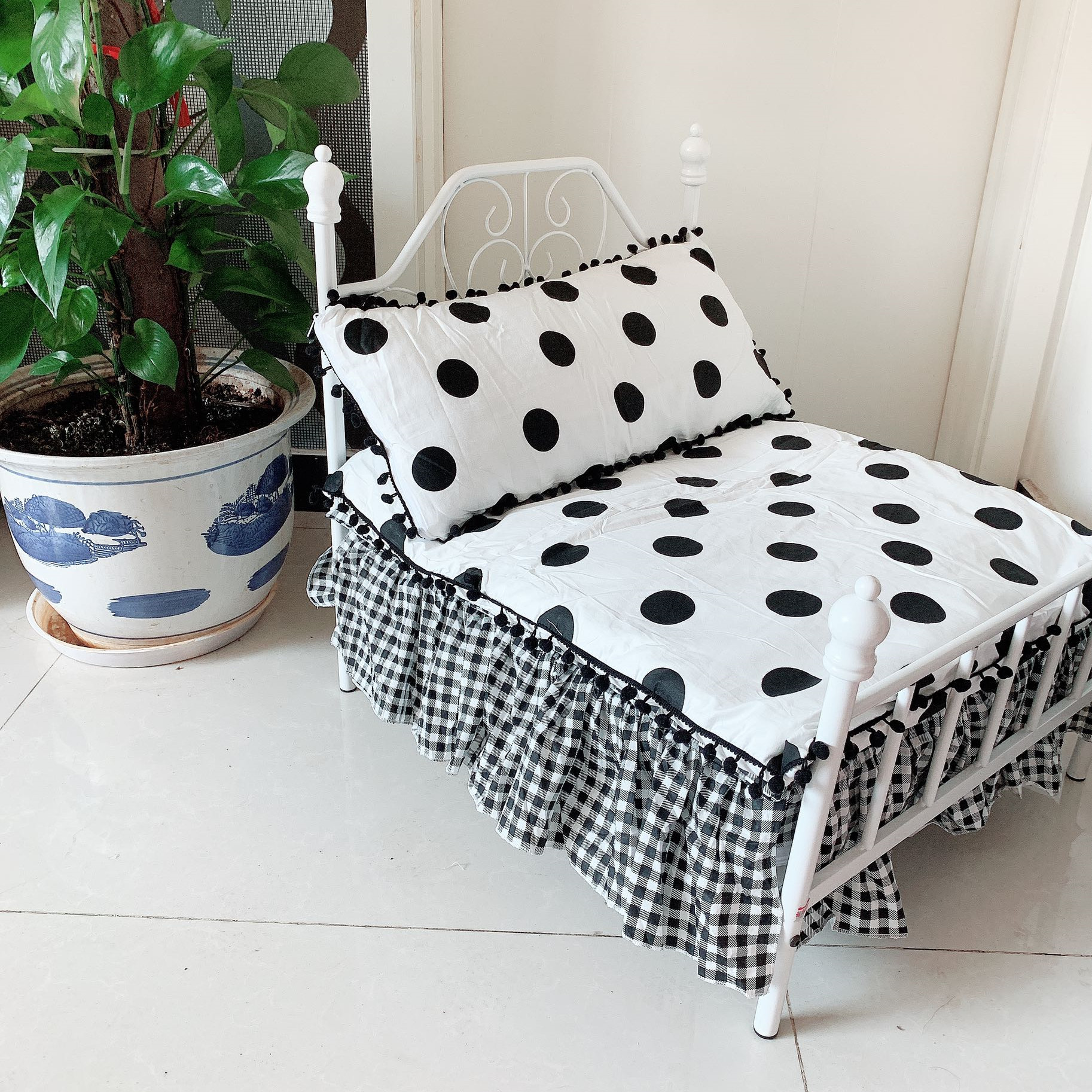 White bed andblack polka dots