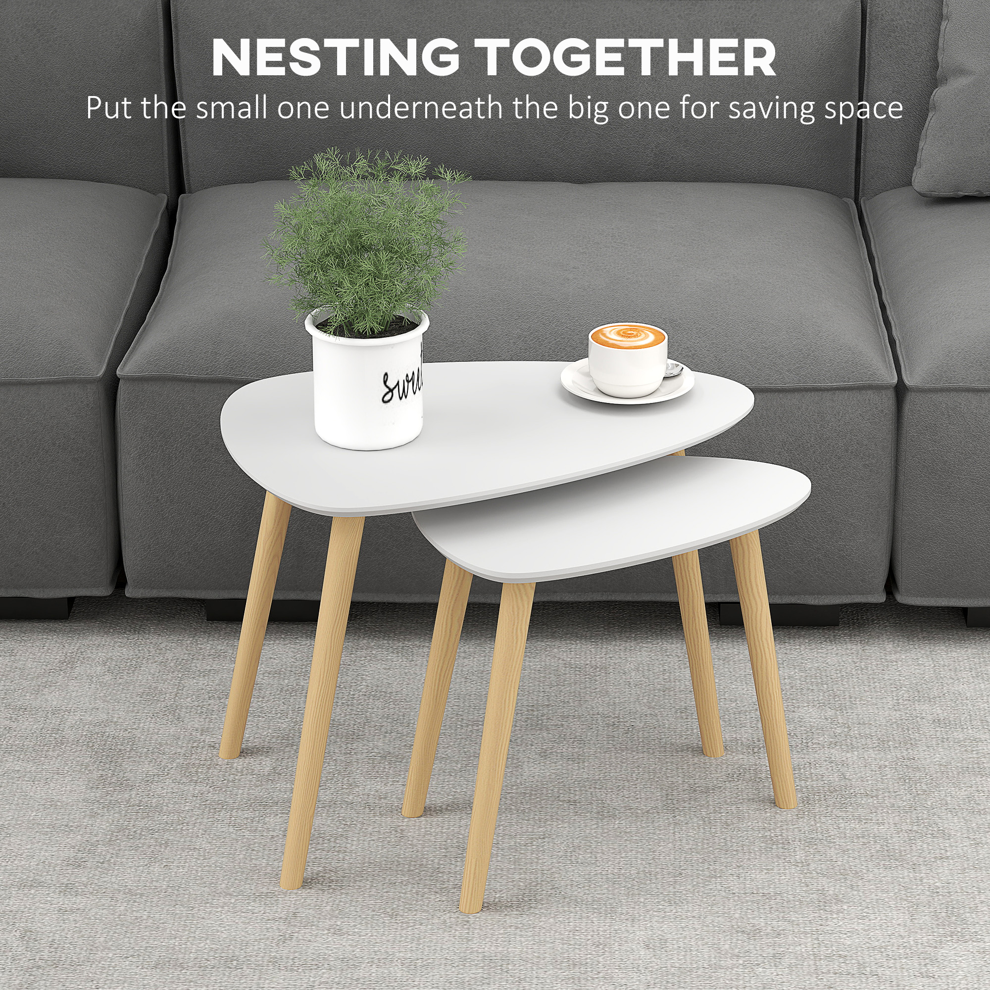 Light grey two-piece nesting tables with triangular tops and natural pine legs.
