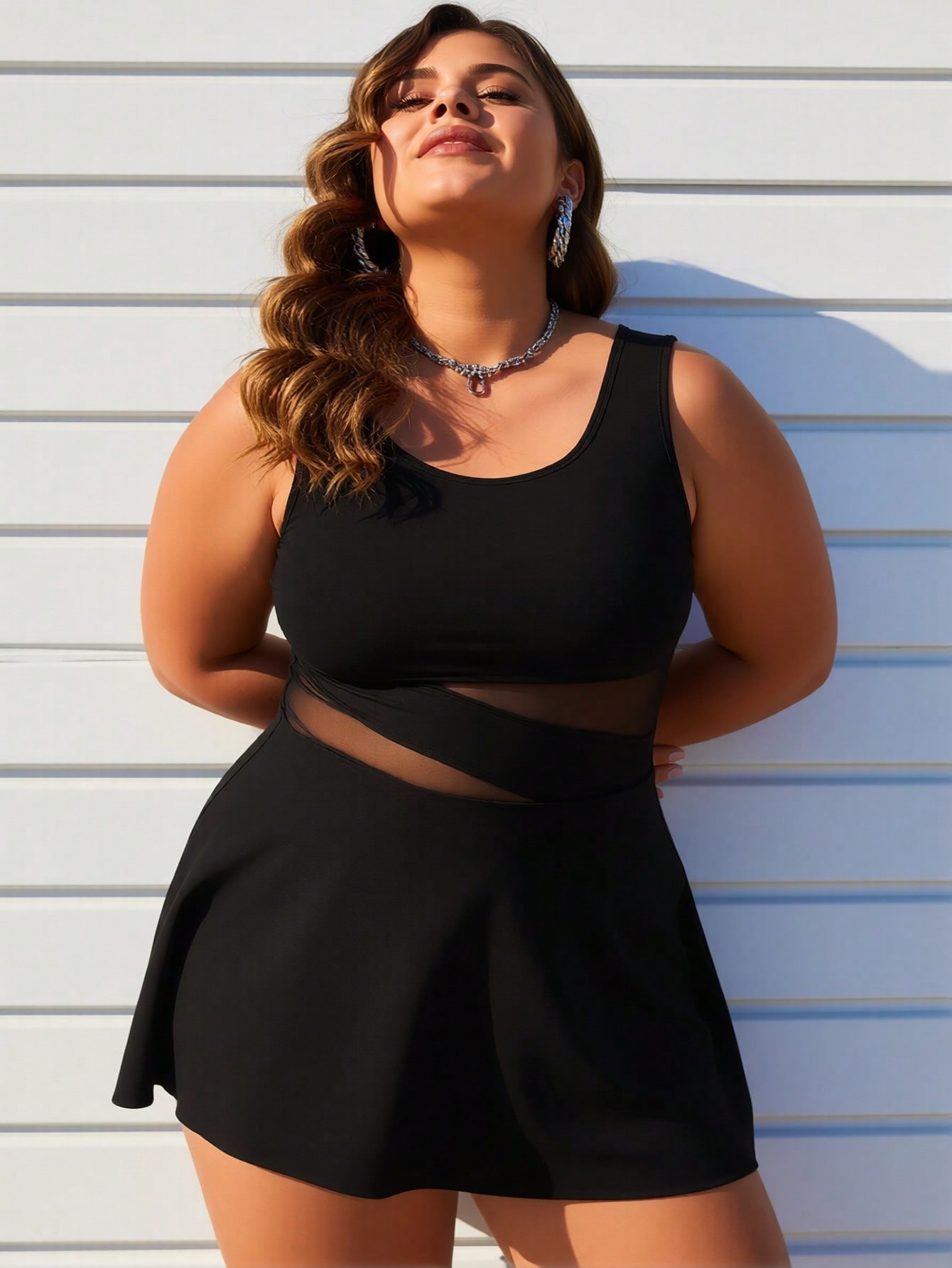 Women's plus size swimdress detail — sheer mesh cutout waist and flared skirt close-up