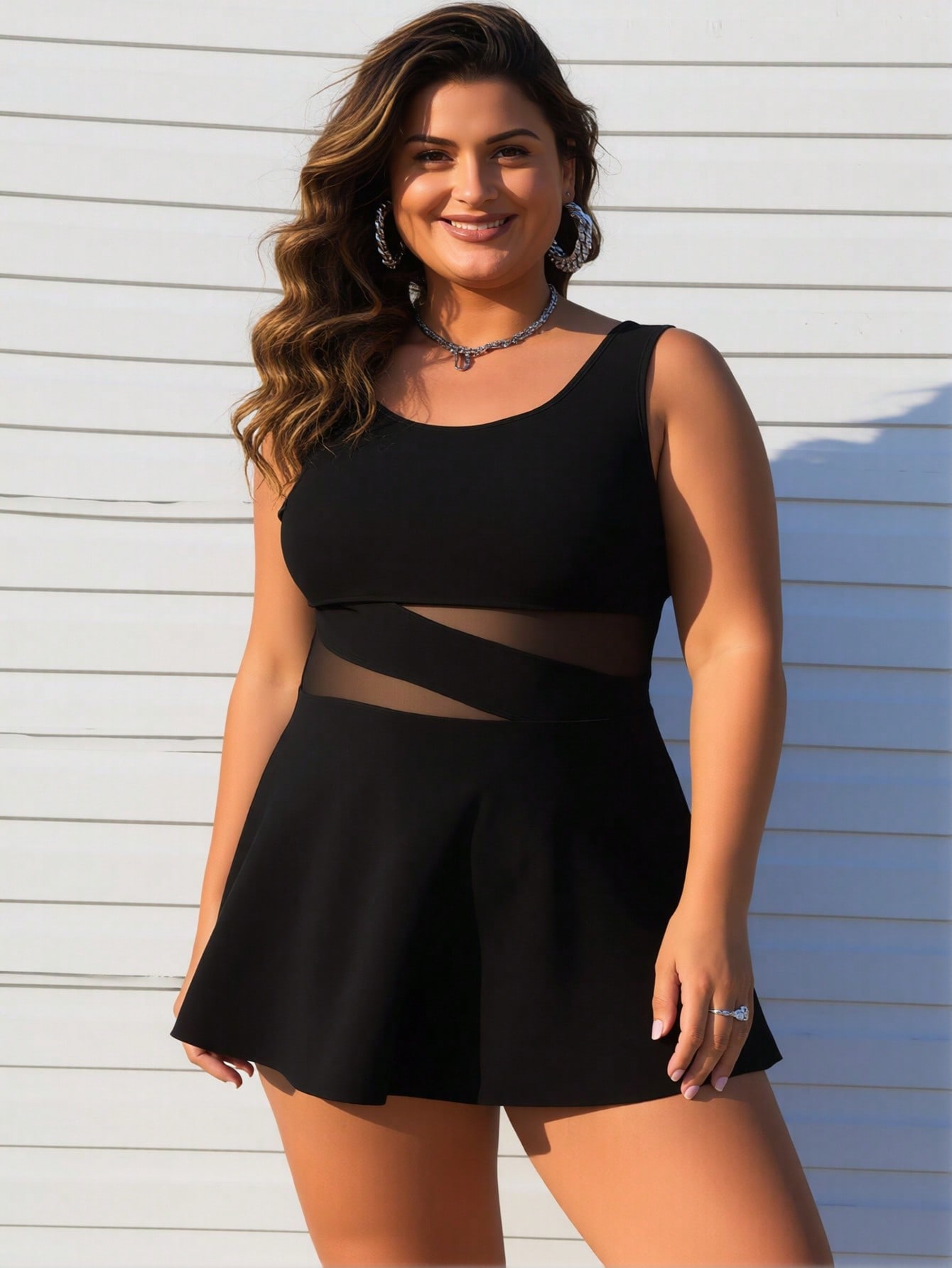 Women's plus size black swimdress with mesh cutout waist — lifestyle front view
