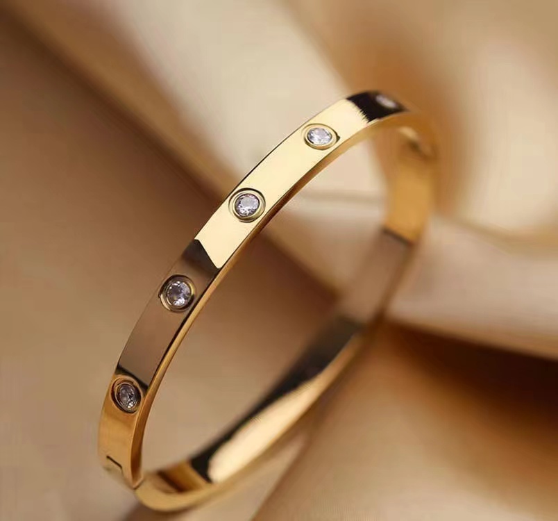 gold-plated-friendship-bracelet-cubic-zirconia-hypo-allergenic-surgical-grade-316L-stainless-steel-love-bright-shiny-smooth-edges-light-heavy-jewelry-box-worn-alone-rings-earrings-charm-inner-circumference-6.7-inches-inner-diameter-2.24-inches-x-1.85-inch