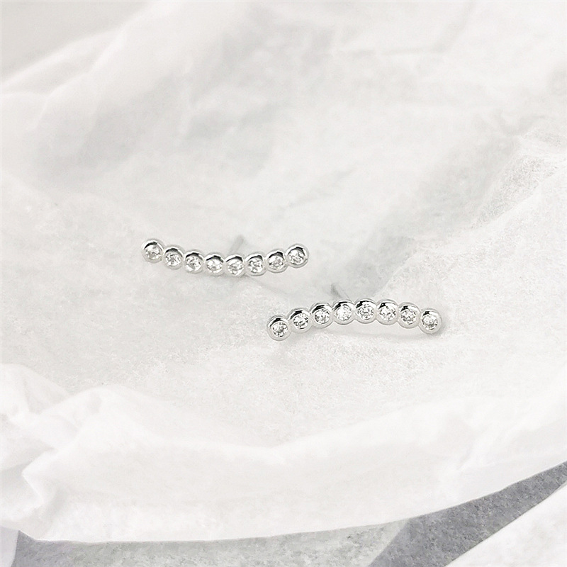 Row of drill zircon earrings