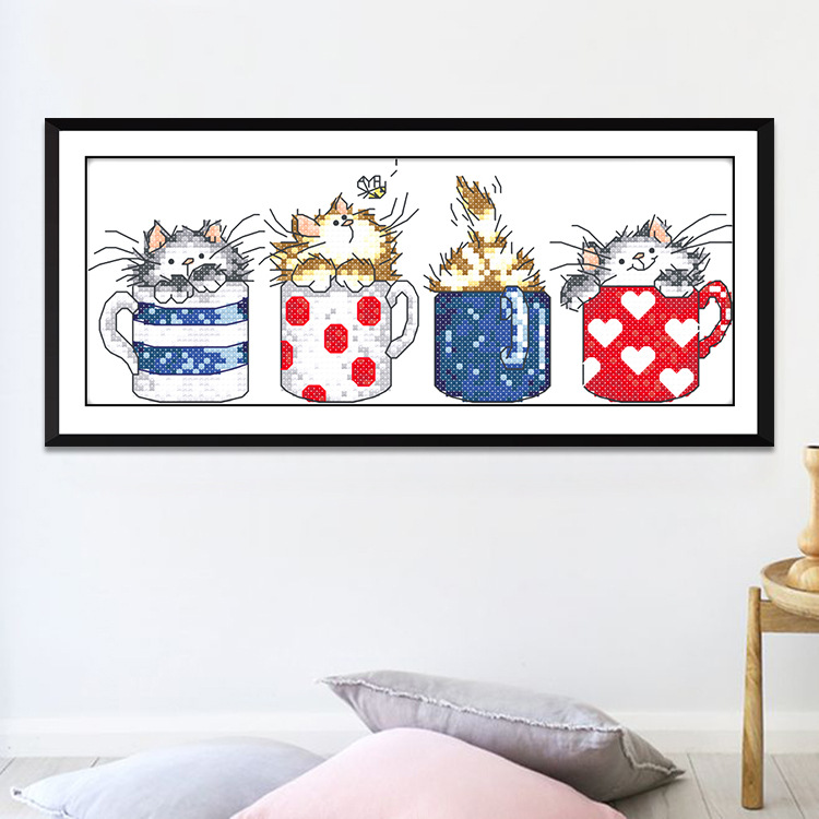 Cartoon cross stitch of kitten in cup