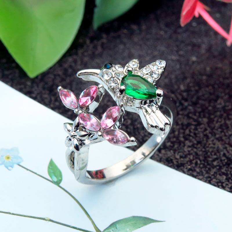 Ring with pink emeralds and colored zircons