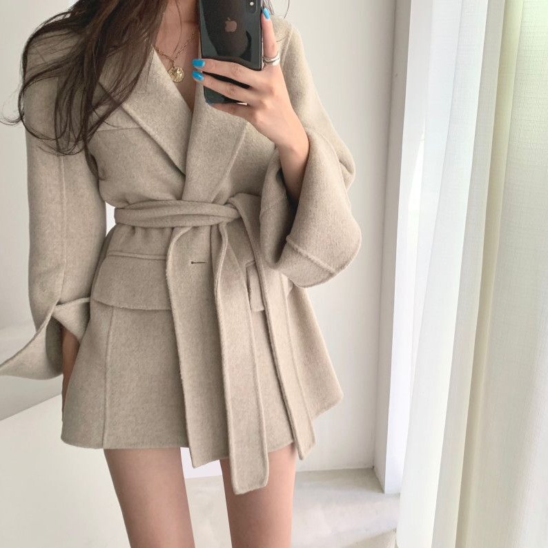 A buckle lace up waist slimming long sleeve woolen coat