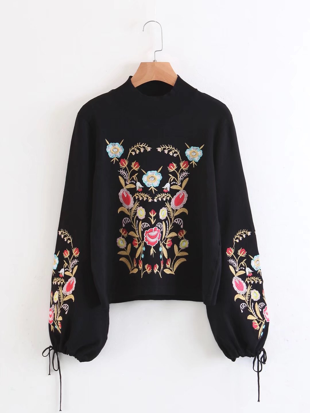 Knit sweater with embroidered cuffs