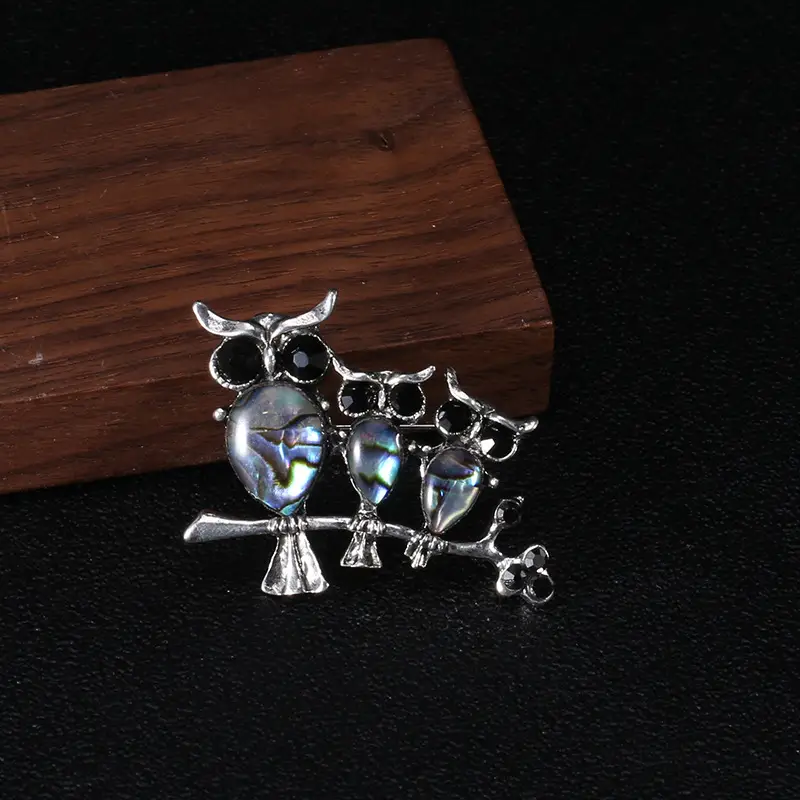 Seashell owl brooch