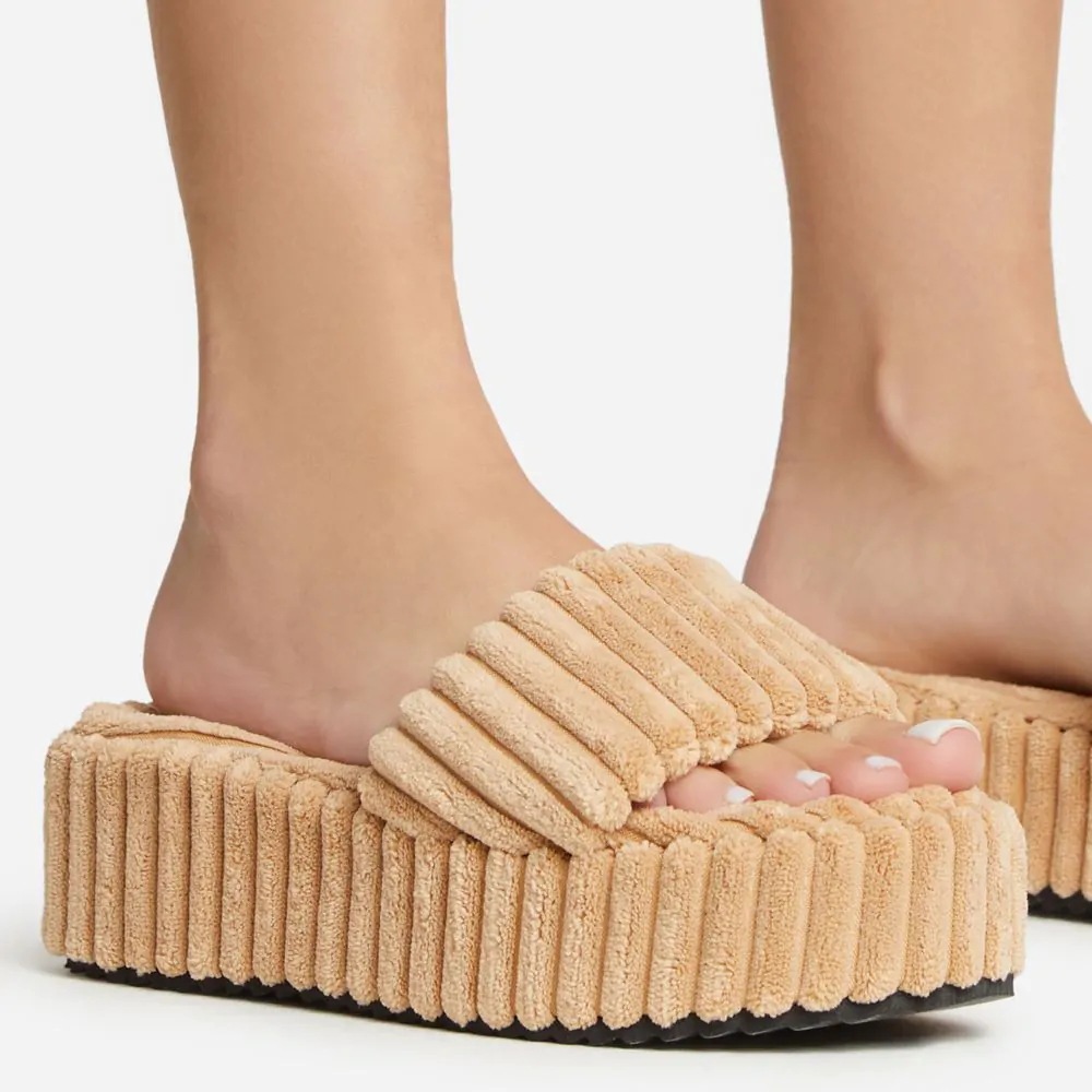 Wearing Plush Slippers With A Large Thick Sole On The Outside