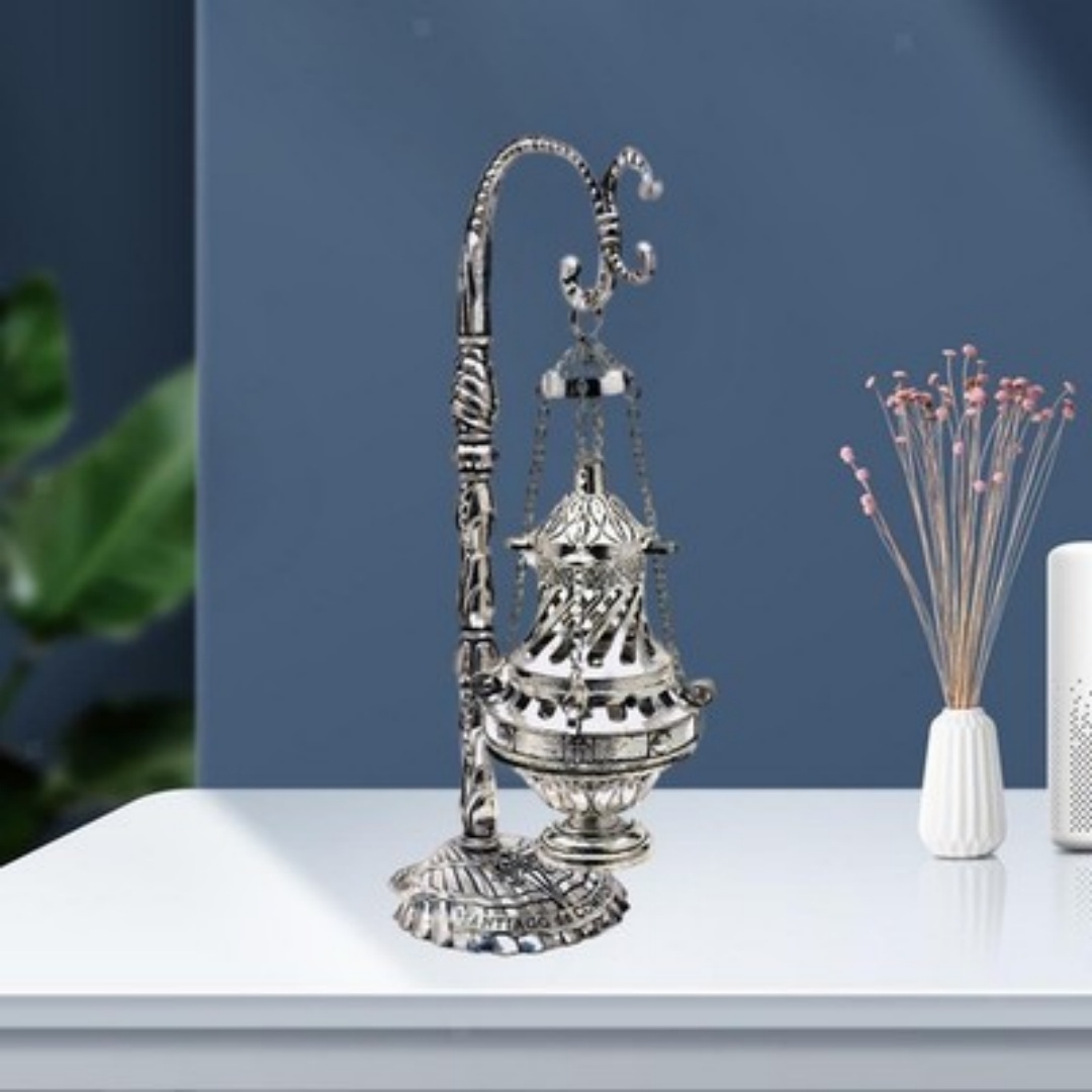 Ornate silver hanging censer with pierced cover on a freestanding metal stand