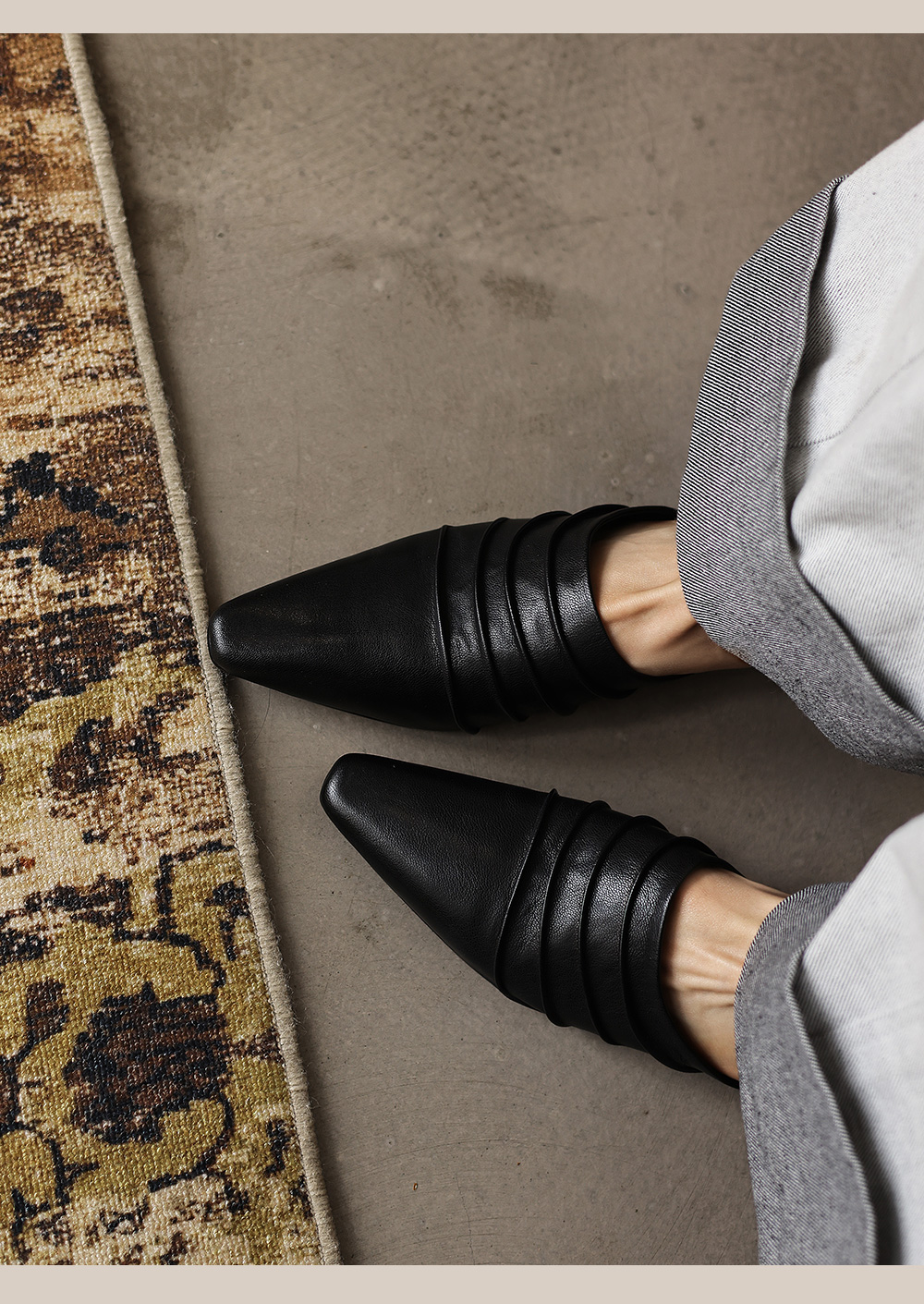 Sheepskin mule slides styled with linen trousers and casual summer outfit