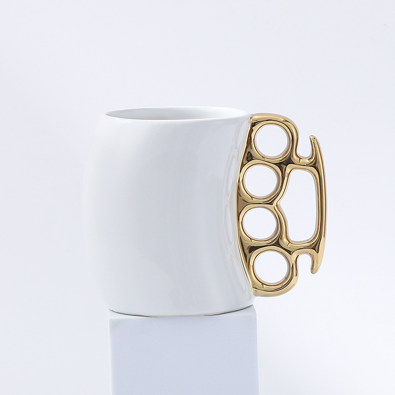 White cup with gold handle