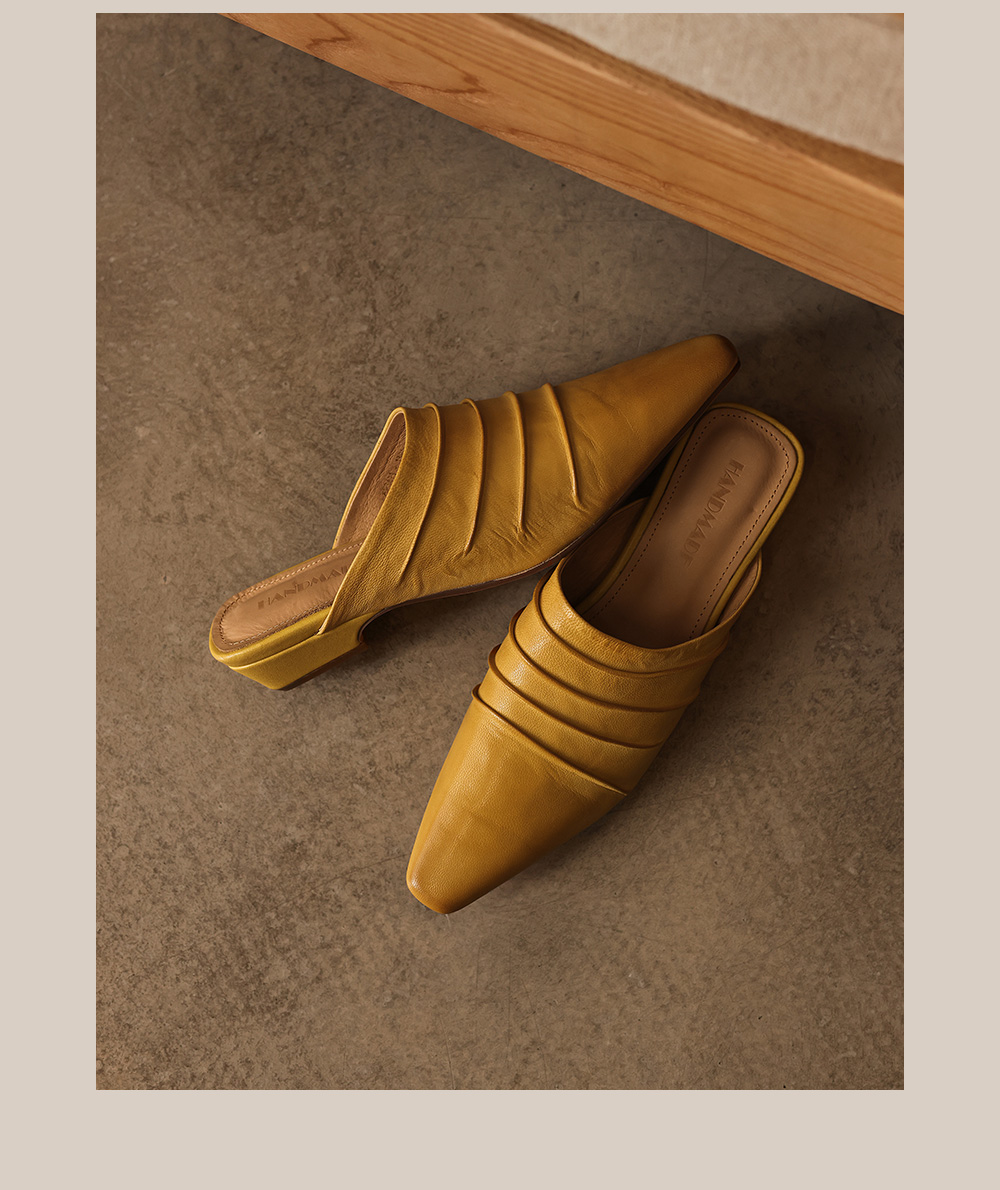 Full-grain leather mule slides showing pigskin lining and cowhide insole detail
