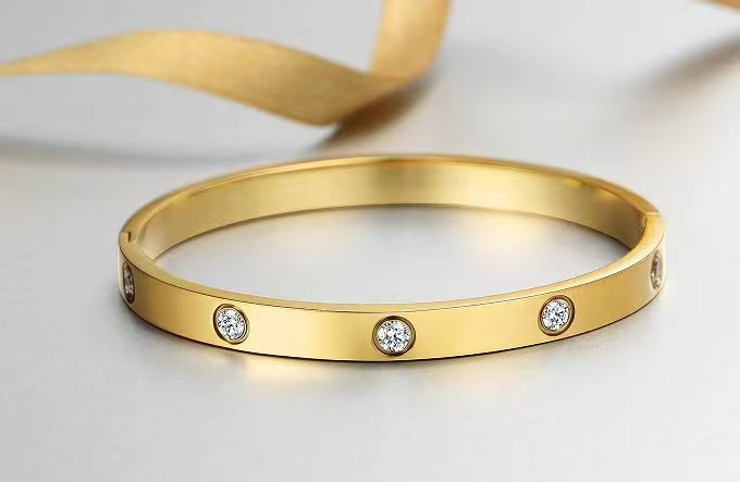 gold-plated-friendship-bracelet-cubic-zirconia-hypo-allergenic-surgical-grade-316L-stainless-steel-love-bright-shiny-smooth-edges-light-heavy-jewelry-box-worn-alone-rings-earrings-charm-inner-circumference-6.7-inches-inner-diameter-2.24-inches-x-1.85-inch