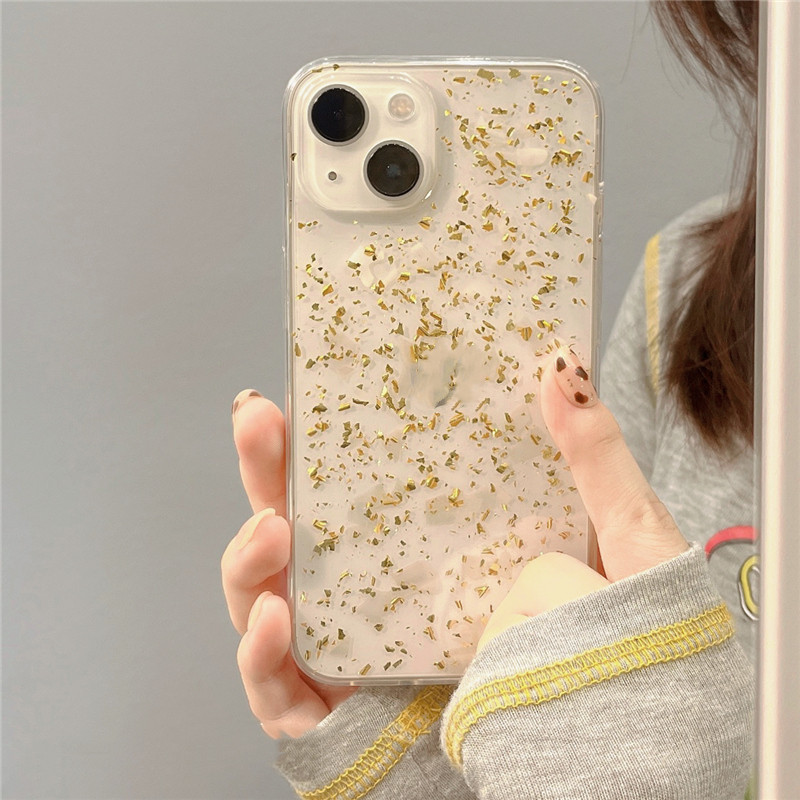 Funda de teléfono transparente con borde dorado y papel aluminio