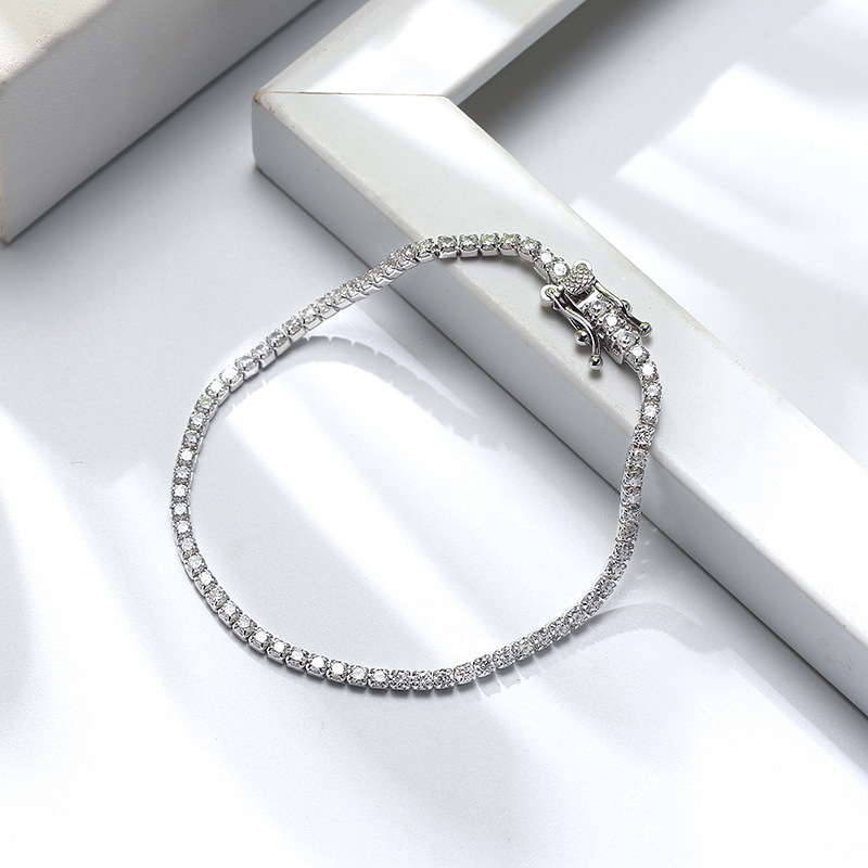 Title 5, Single row zircon sterling silver bracelet. A b...