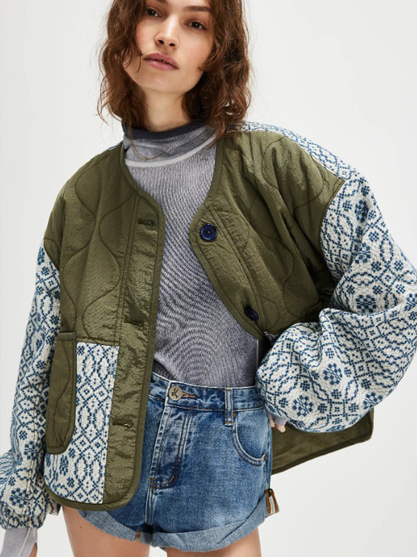 Women's quilted patchwork coat detail — printed patchwork and button closure close-up
