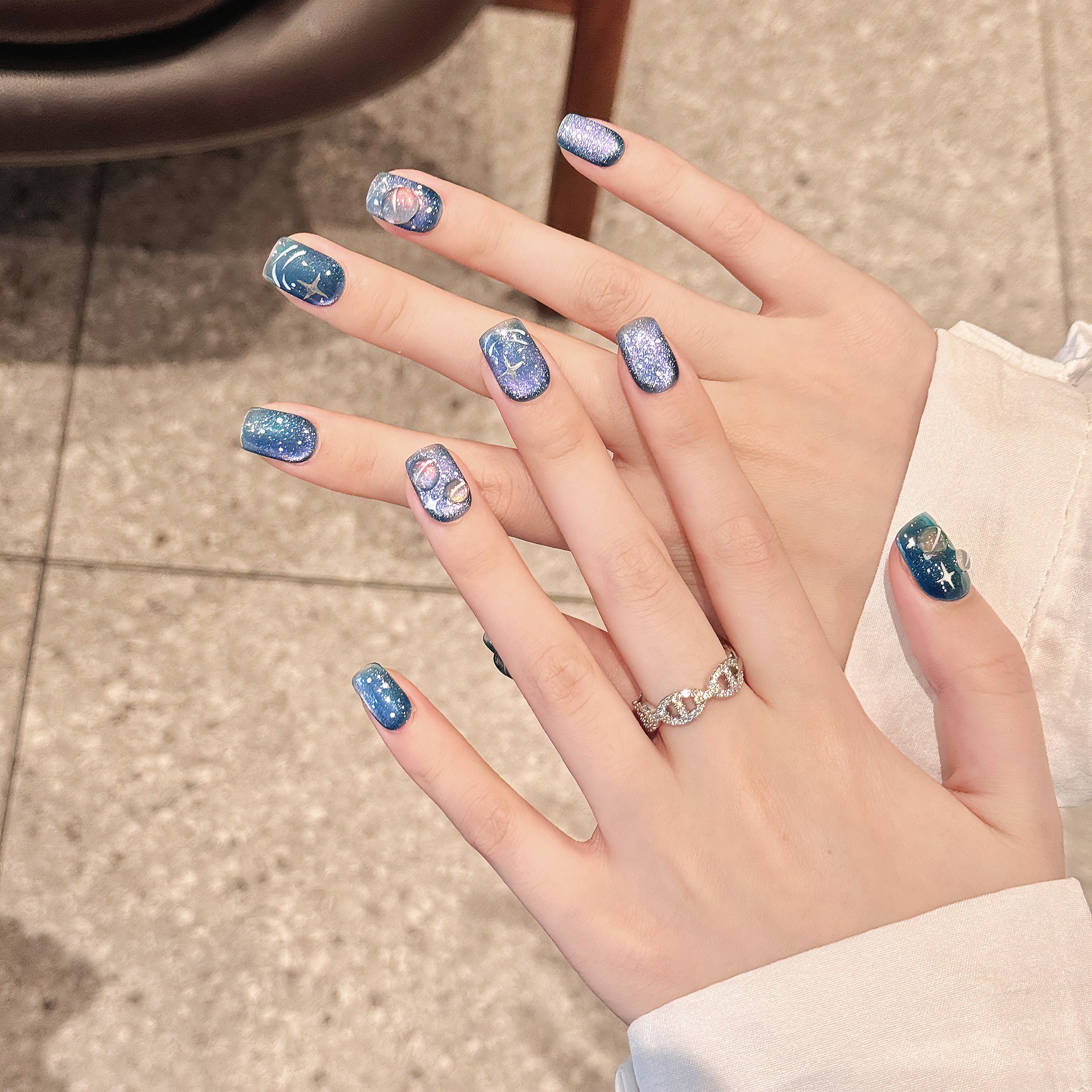 Hand-painted Wearable Nail Art Featuring A Blue Starry Sky And Nebula Design