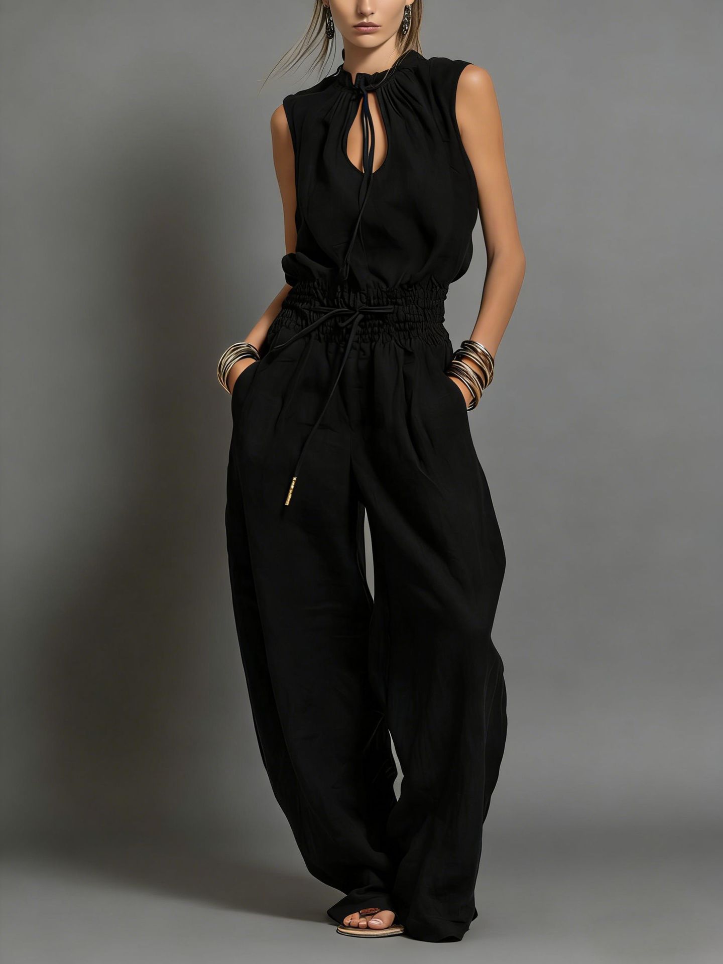 Women's pleated jumpsuit in brown, side view showing wide-leg silhouette and high waist