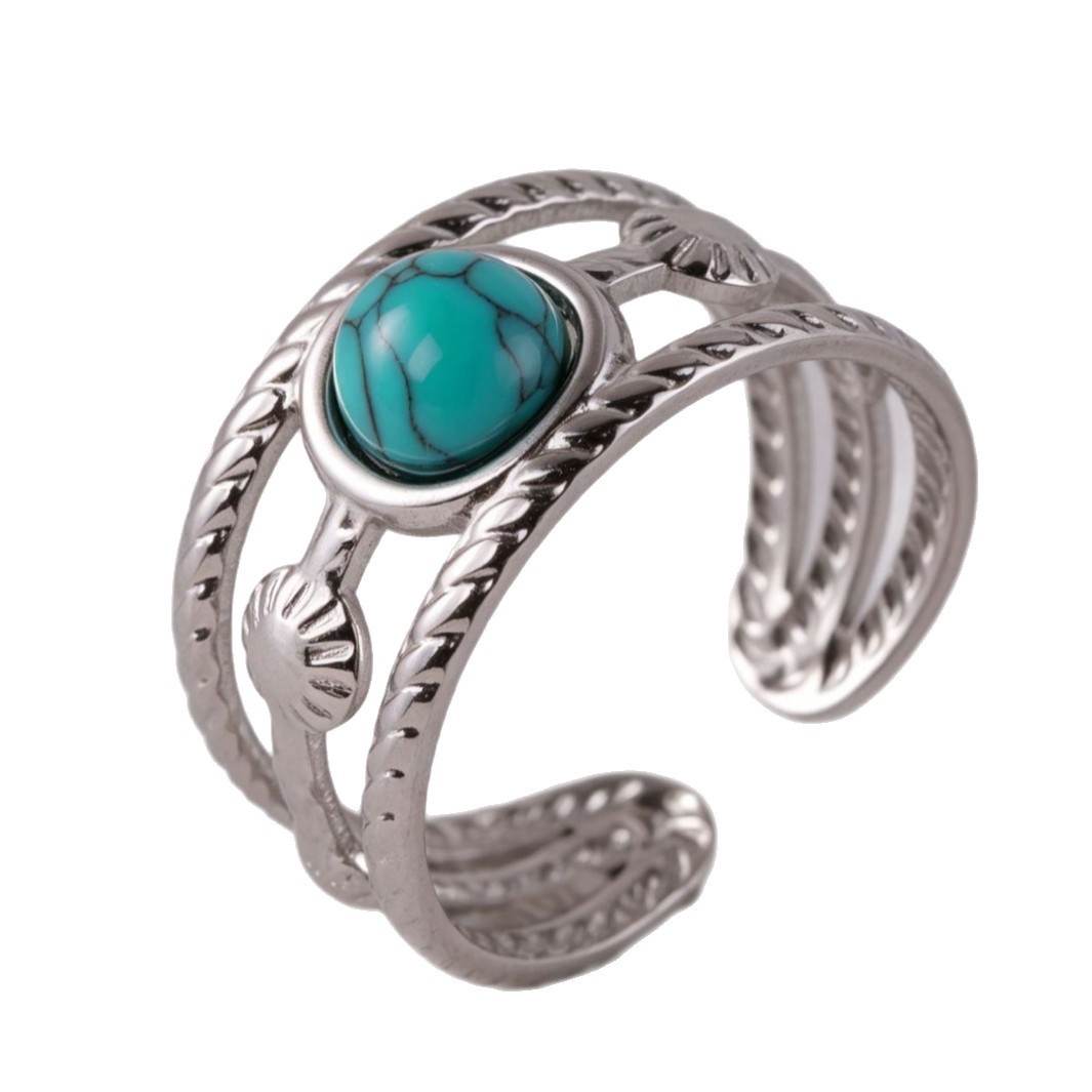 Close-up silver wide-band turquoise ring with adjustable openwork design