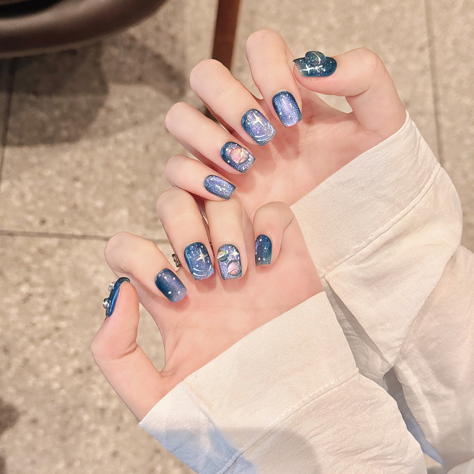 Hand-painted Wearable Nail Art Featuring A Blue Starry Sky And Nebula Design