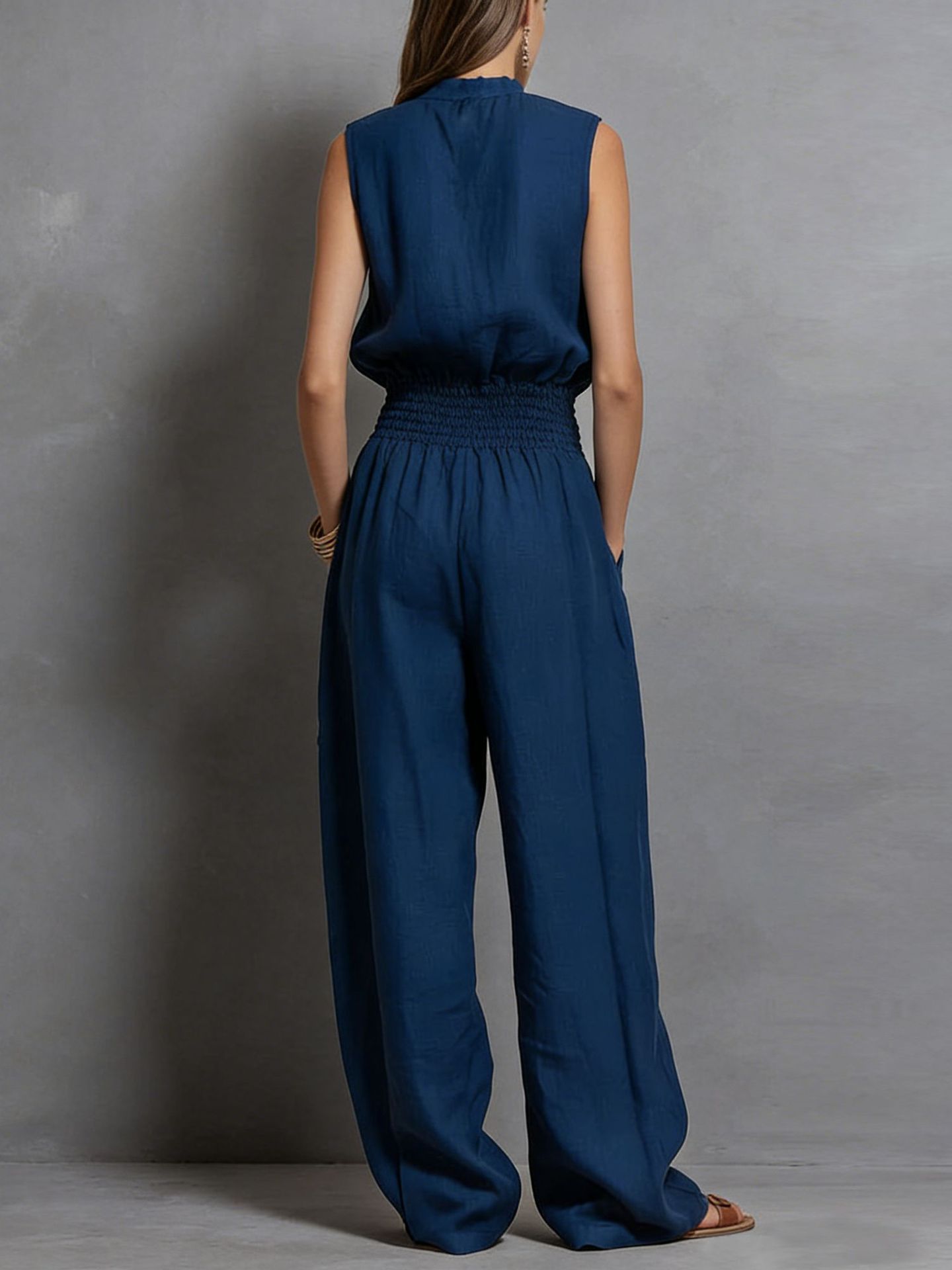 Women's sleeveless wide-leg jumpsuit in black, back view showing full length