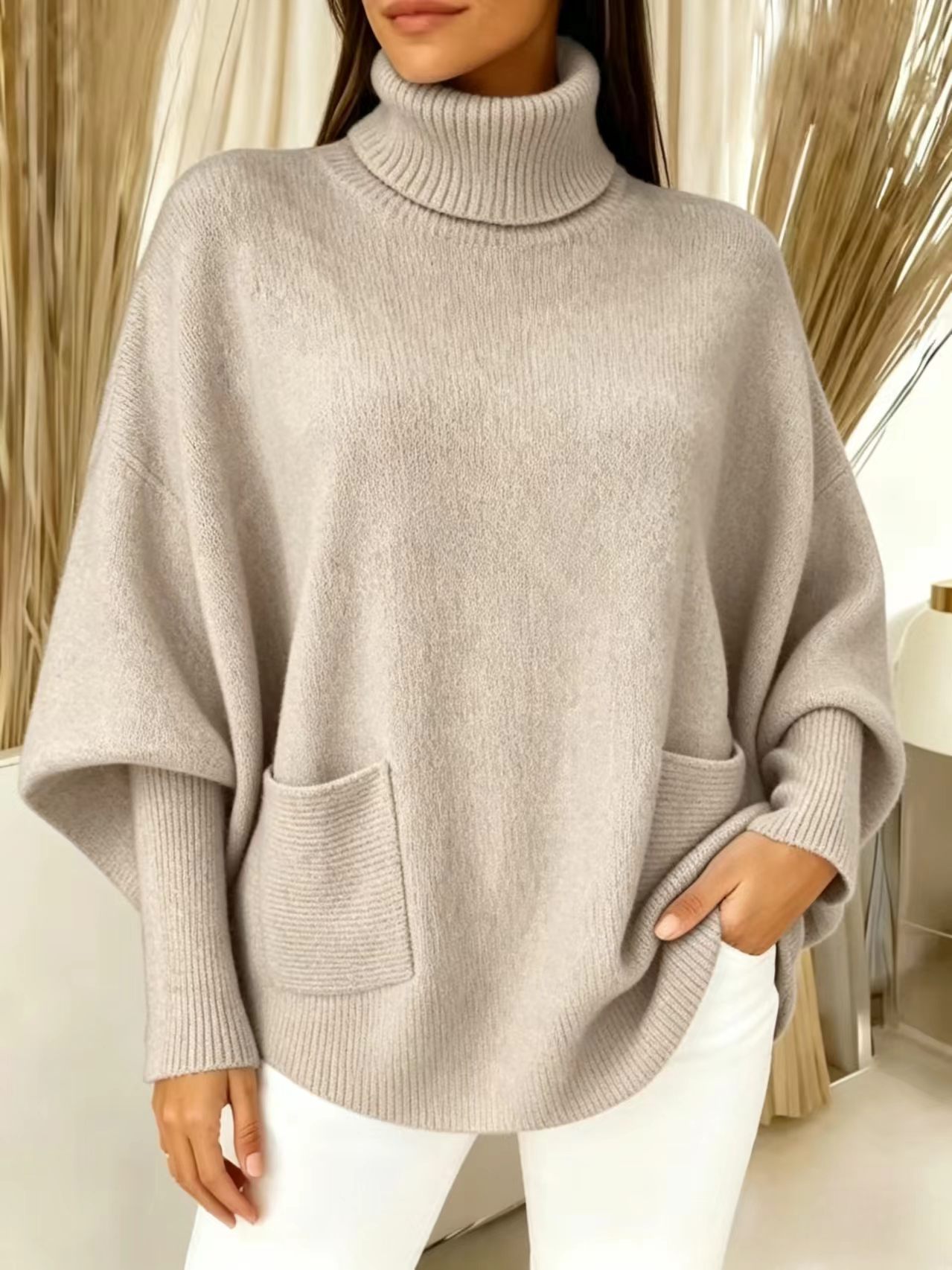 Women's oversized knit sweater – detail shot of batwing sleeve and ribbed cuff