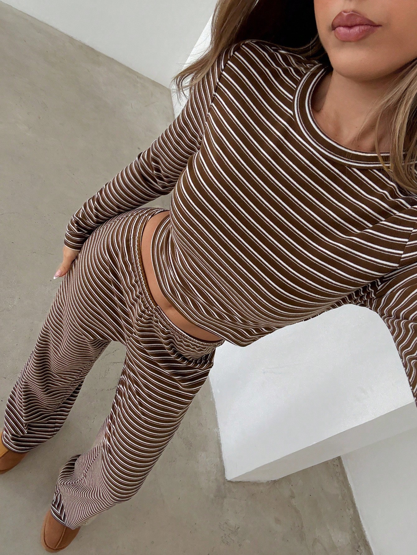 Front view of women's striped long-sleeve two-piece outfit