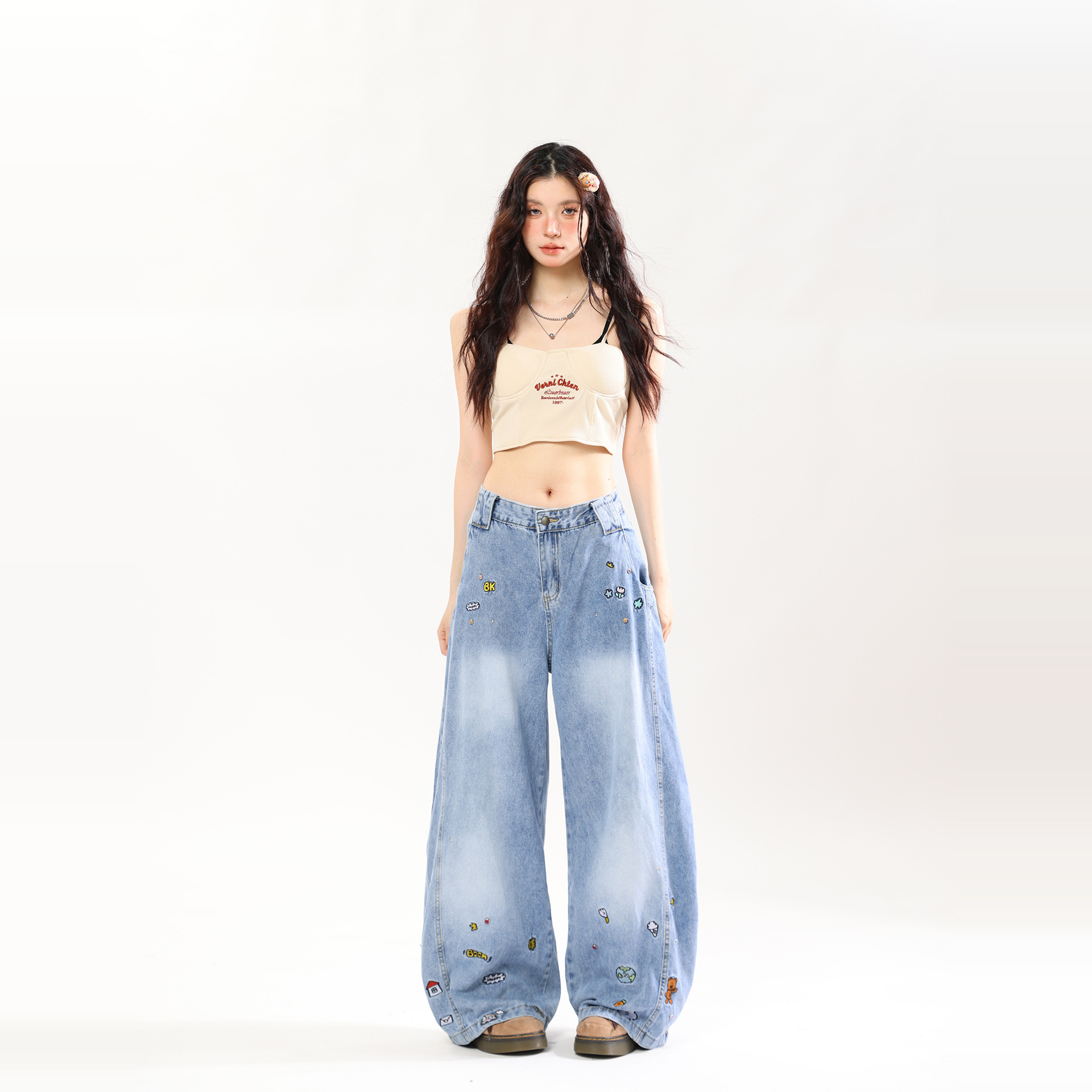 A pair of retro-style wide-leg jeans with cartoon embroidery.
