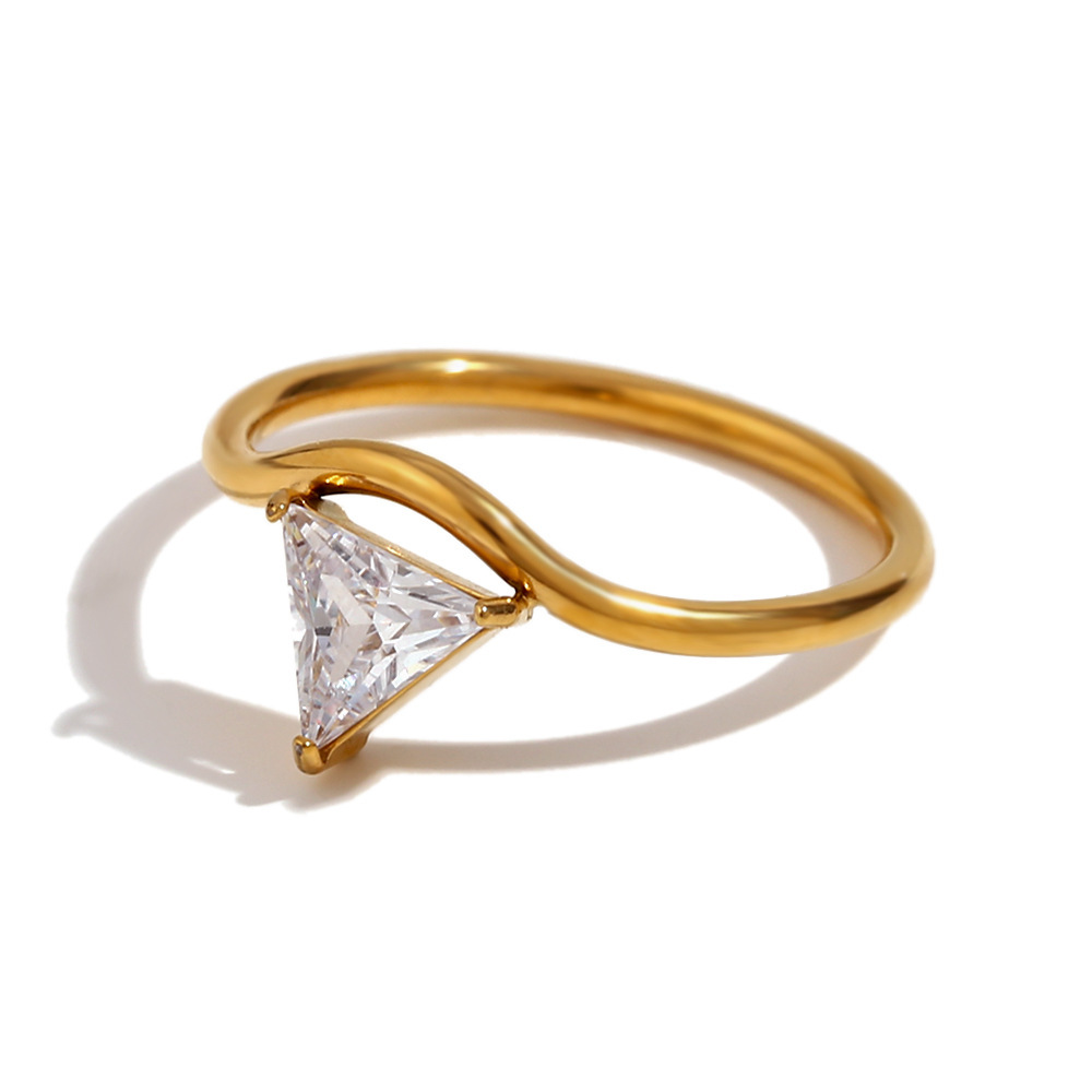 Close-up of gold wave ring with triangle cubic zirconia stone