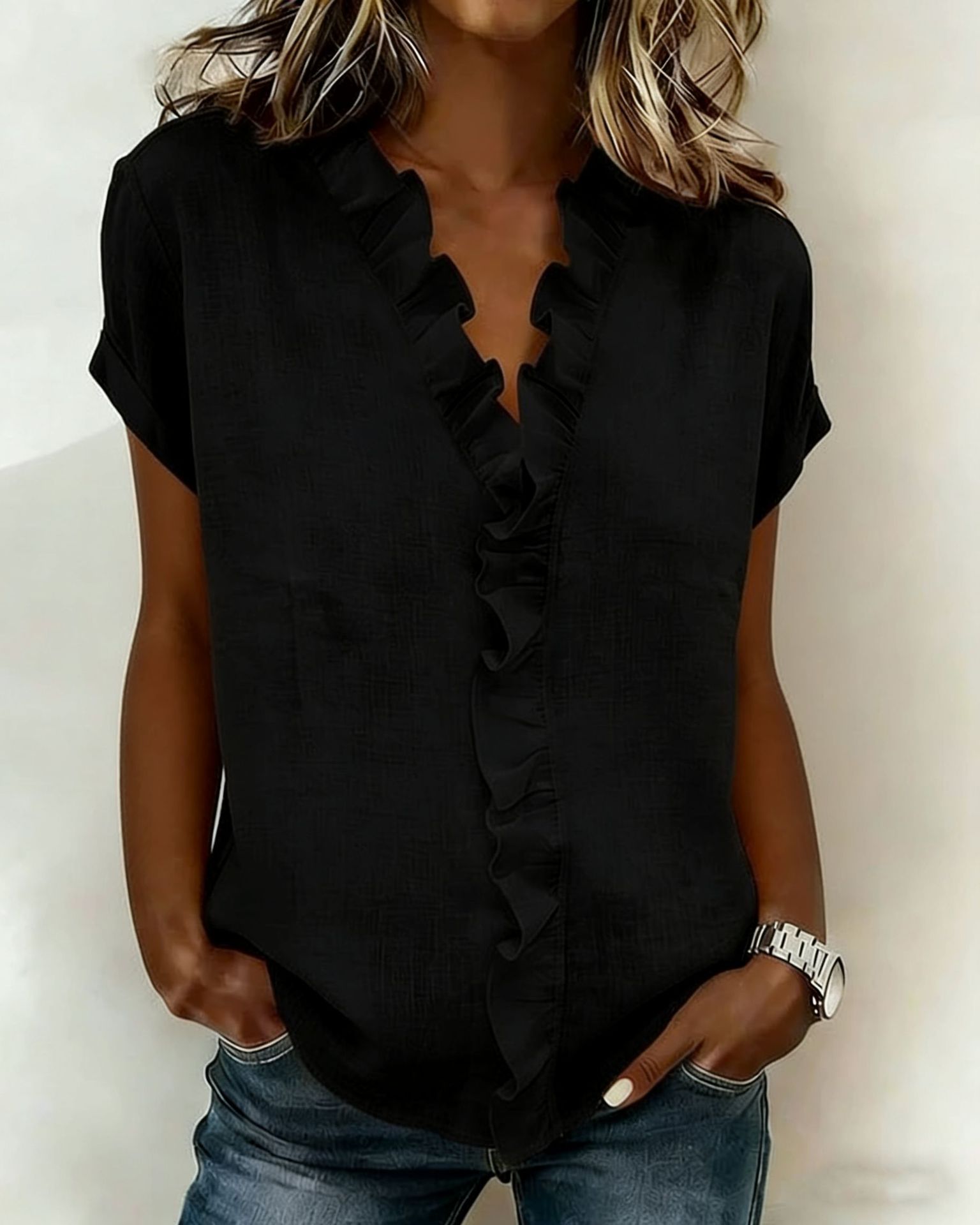 Ruffle sleeve top in black, model wearing outdoor lifestyle editorial shot