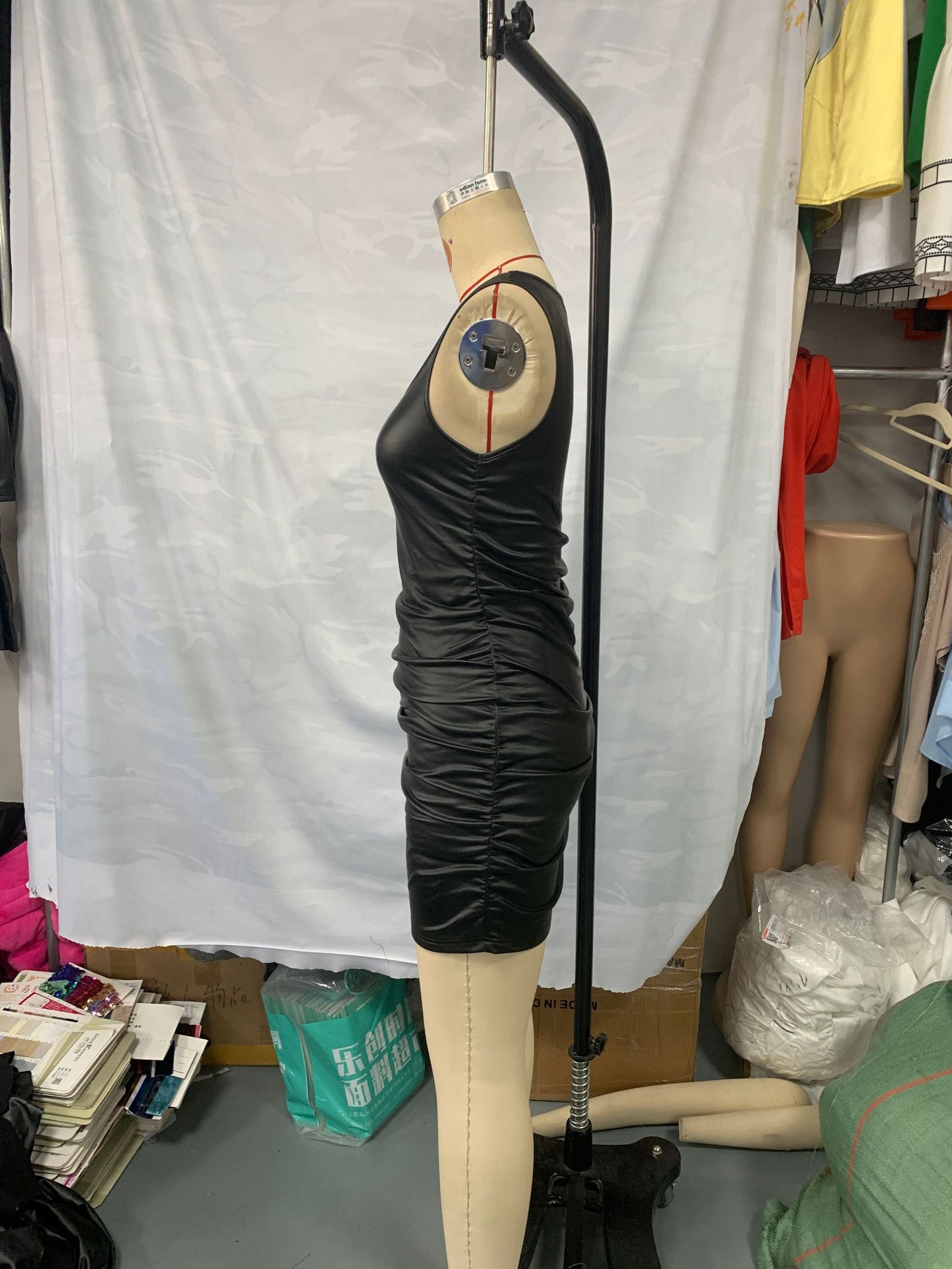 black slip dress ethereal pleats catching light during movement lifestyle shot