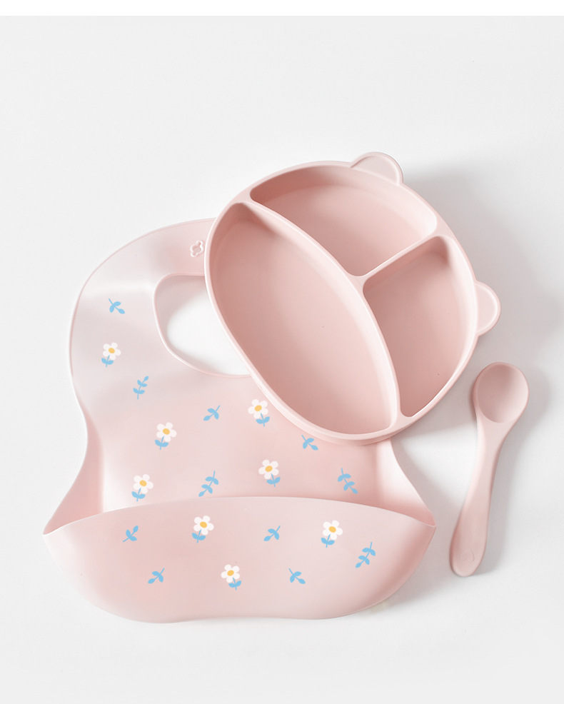 Baby bib and bowl set with floral patterns on a white background