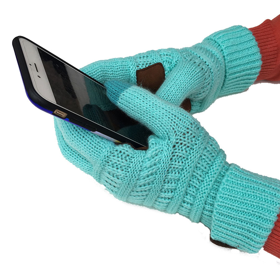 A person wearing European and American wool knitted turn-over labeling touch screen gloves is holding a smartphone and interacting with the screen, embracing the winter chill.