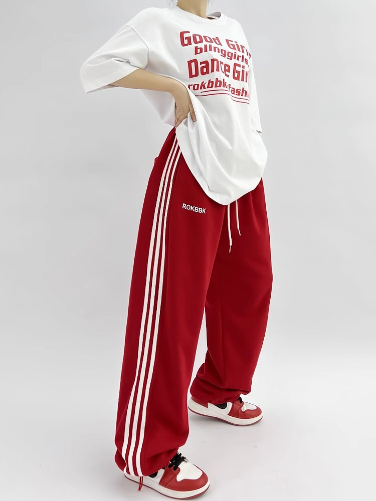 Embroidered wide-leg sweatpants, final lifestyle photo showing full silhouette
