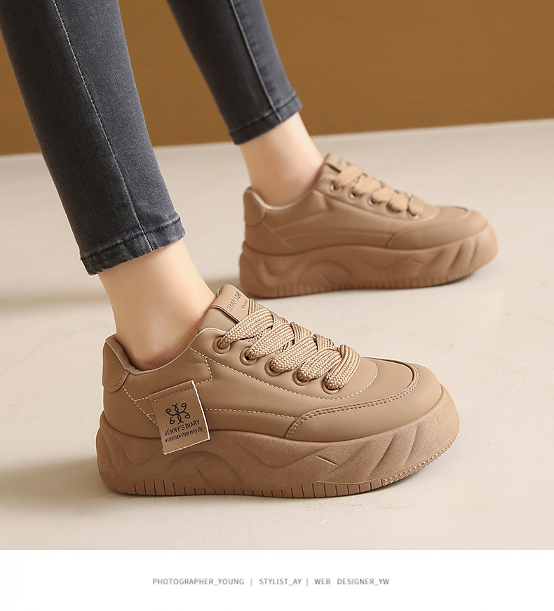 Height increasing sneakers in black colorway showing color block stitching detail