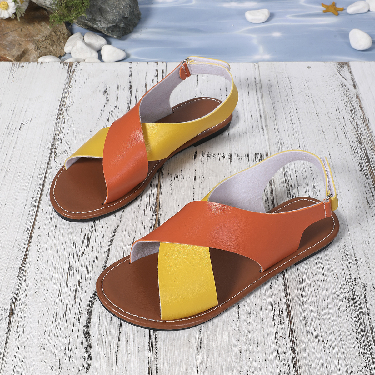 Women's color-block cross-strap flat sandals in Orange – Velcro closure sandal, sole view showing PVC outsole and cemented construction