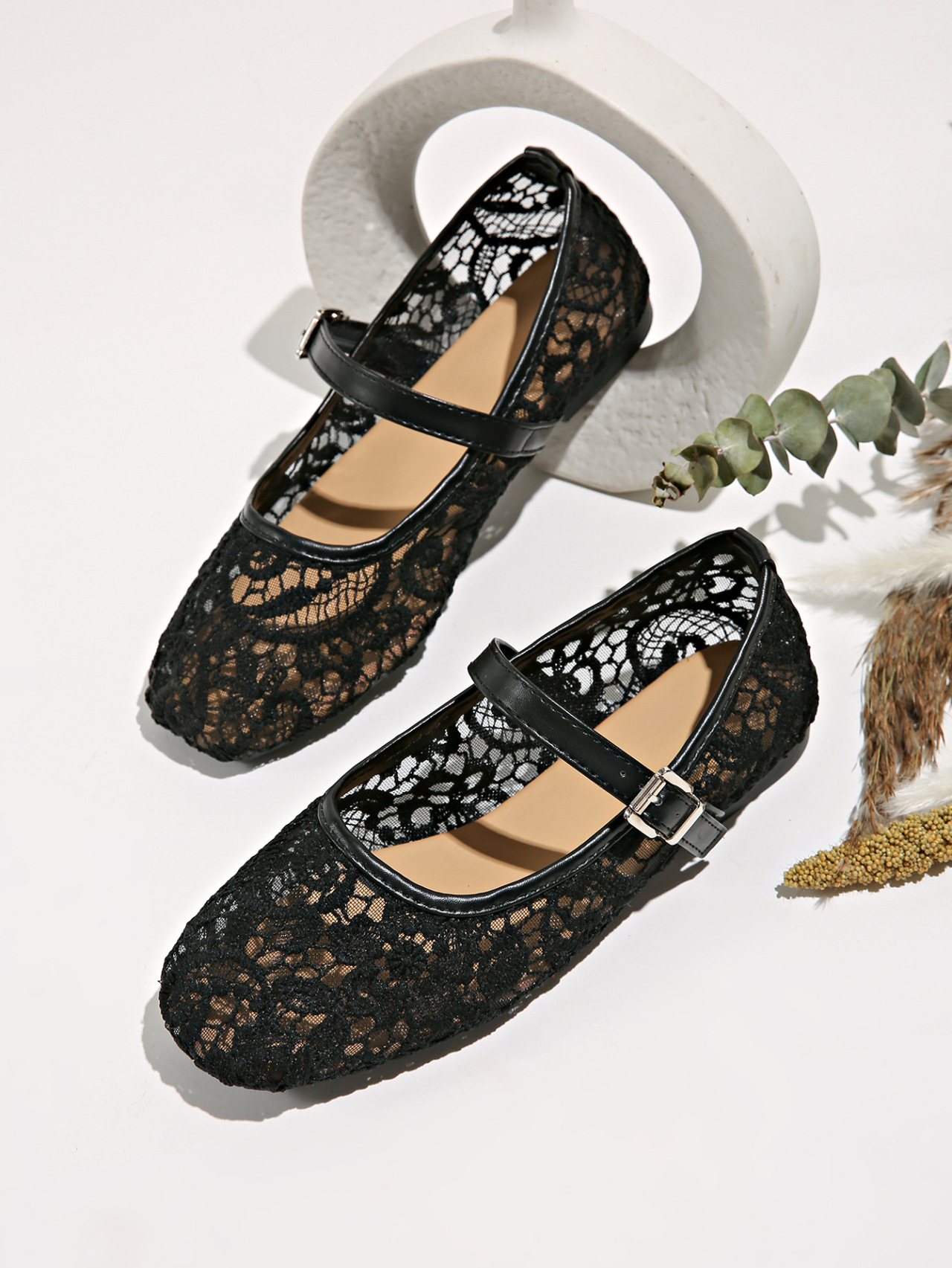 White Mary Jane flats with lace detail - lifestyle editorial photo