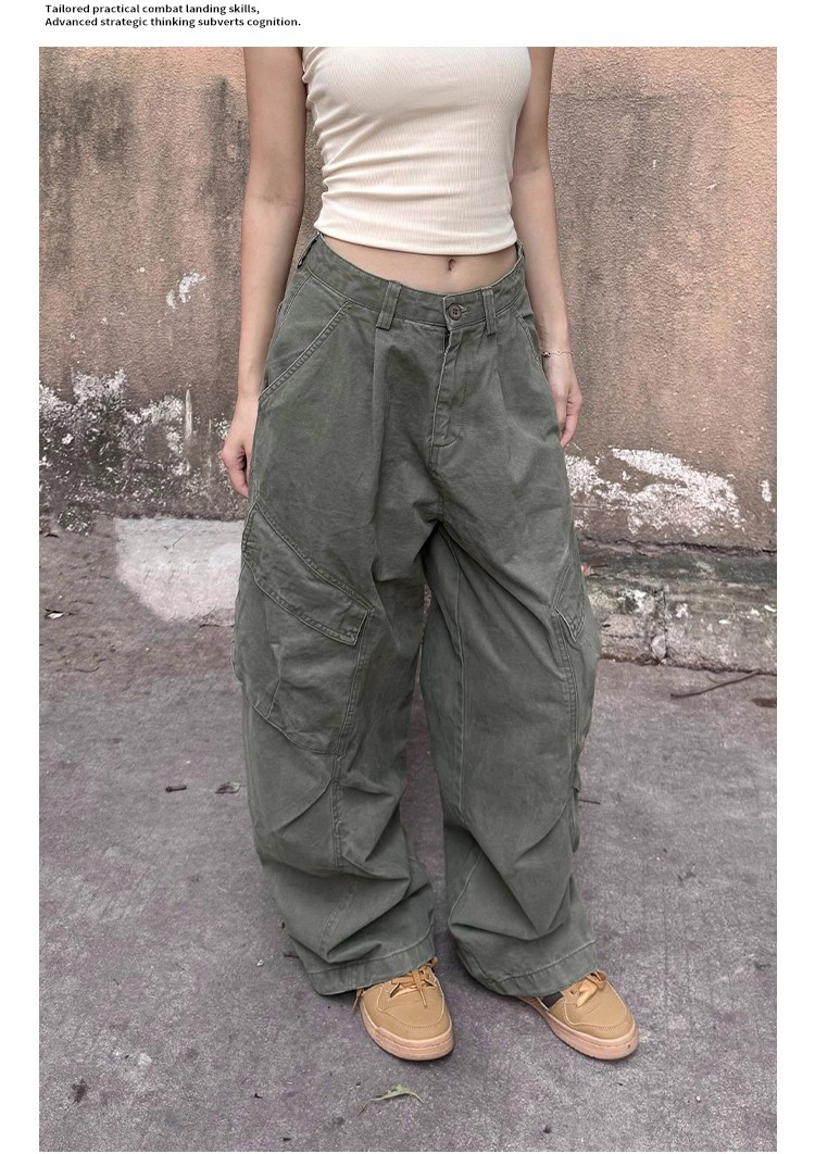 Army-green cargo trousers showing the front waistband, angled flap pockets and shaped wide-leg seams